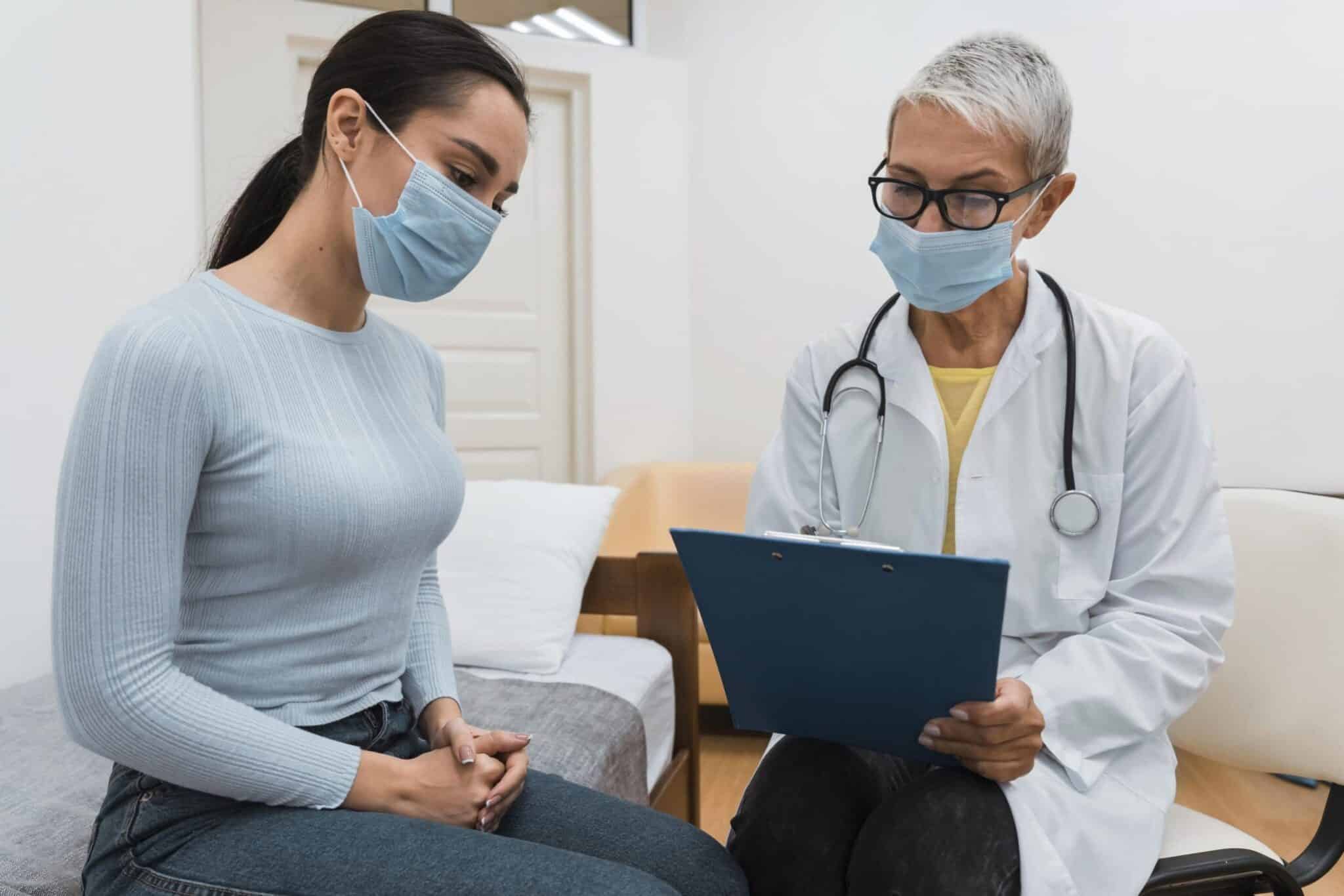 doctor showing clipboard patient scaled